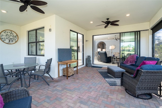 sunroom featuring ceiling fan