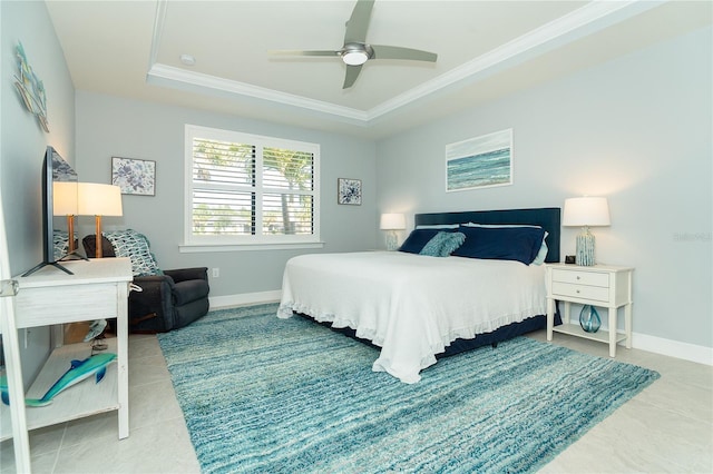 tiled bedroom featuring crown molding, a tray ceiling, and ceiling fan