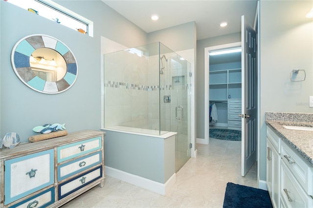 bathroom featuring tile patterned flooring, vanity, and a shower with shower door