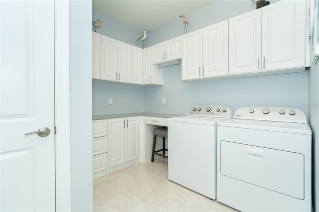 laundry area with washer and clothes dryer and cabinets