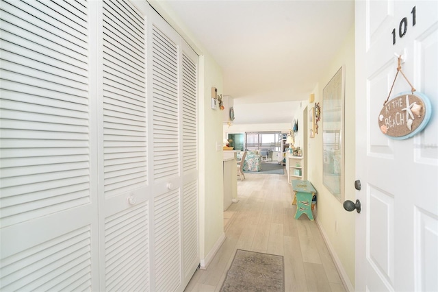 hallway with light hardwood / wood-style flooring