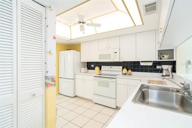 kitchen with sink, white cabinetry, light tile patterned floors, white appliances, and backsplash