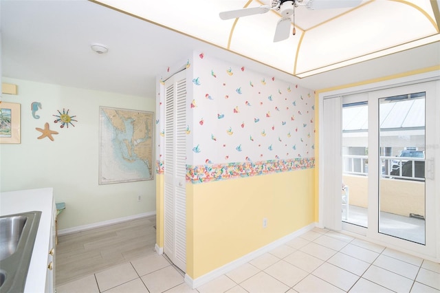 interior space featuring tile patterned flooring, sink, and ceiling fan