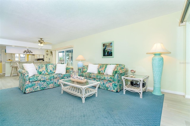 living room featuring ceiling fan and light wood-type flooring