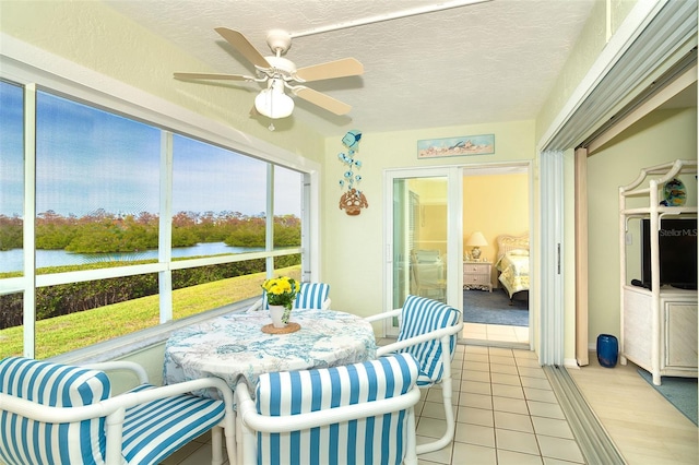 sunroom / solarium featuring ceiling fan