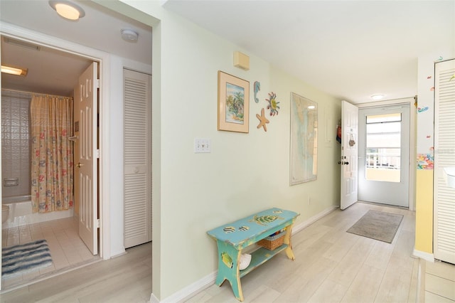 corridor with light hardwood / wood-style floors