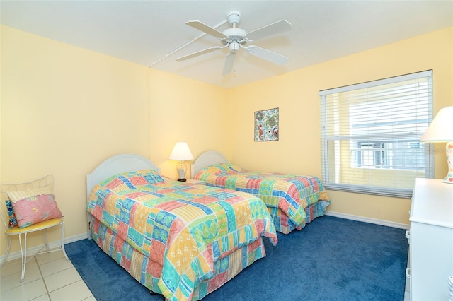 bedroom with dark tile patterned flooring and ceiling fan