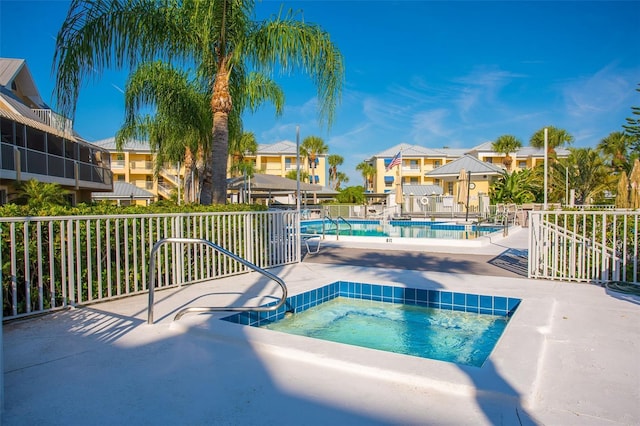 view of pool featuring a hot tub and a patio