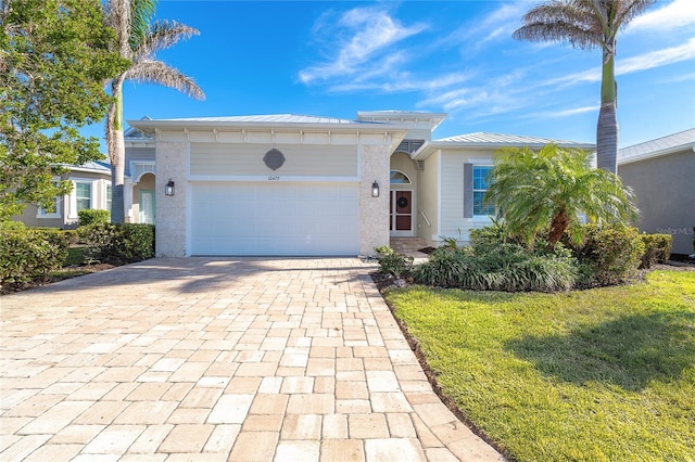 view of front of house with a garage and a front yard