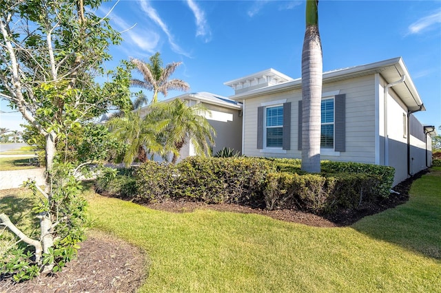 view of property exterior with a yard