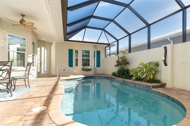 view of swimming pool with a lanai, ceiling fan, and a patio area