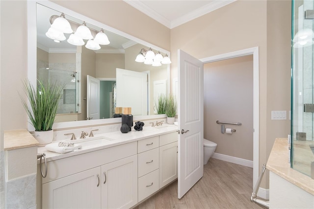 bathroom featuring a shower with shower door, hardwood / wood-style flooring, vanity, toilet, and crown molding