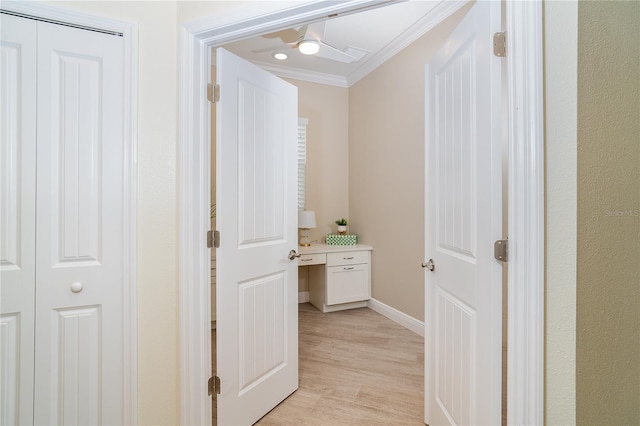 corridor featuring crown molding and light hardwood / wood-style flooring