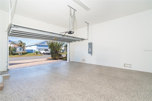 garage featuring a garage door opener and electric panel