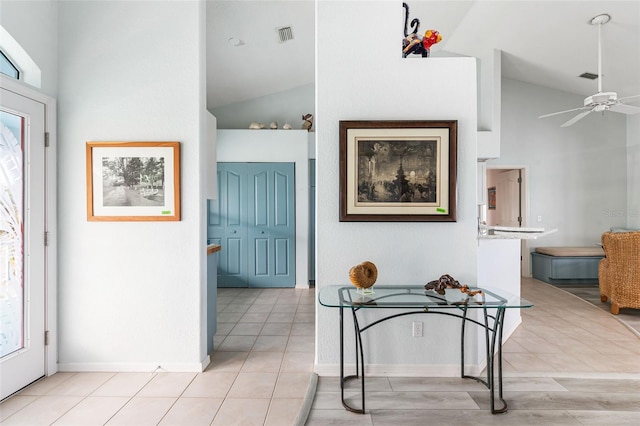 foyer entrance featuring ceiling fan and vaulted ceiling