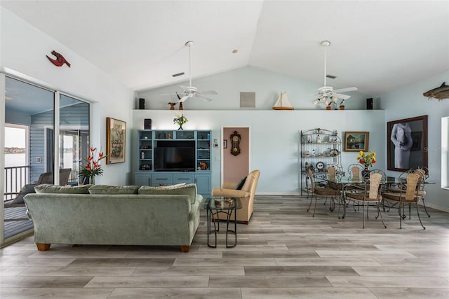 living room with ceiling fan and lofted ceiling