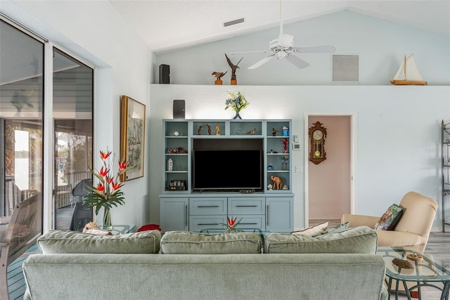 living room featuring ceiling fan and lofted ceiling