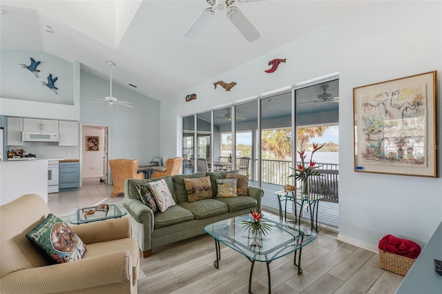 living room featuring ceiling fan, light hardwood / wood-style flooring, and lofted ceiling