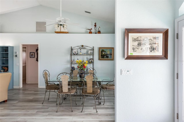 dining room with light hardwood / wood-style floors, lofted ceiling, and ceiling fan