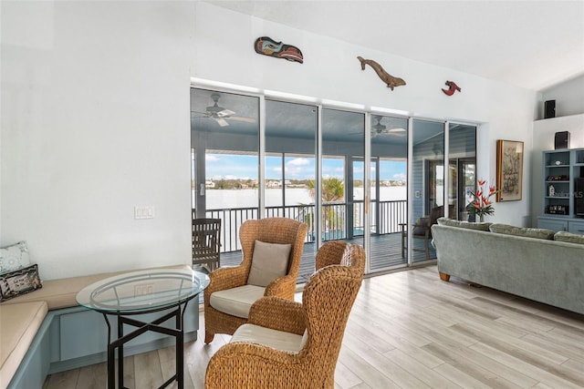 living room with light hardwood / wood-style flooring and ceiling fan