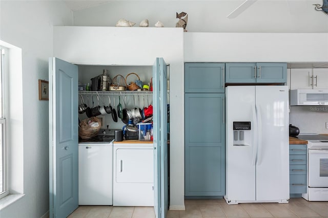 kitchen featuring ceiling fan, white appliances, washing machine and dryer, and light tile patterned flooring