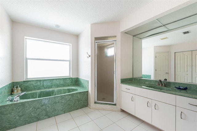 bathroom featuring vanity, tile patterned floors, a textured ceiling, and separate shower and tub