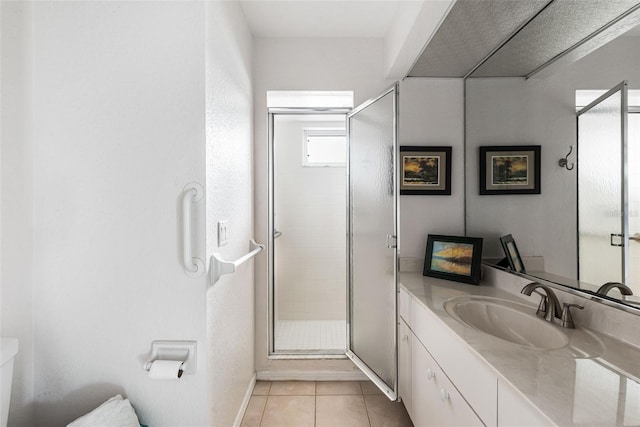 bathroom featuring vanity, toilet, walk in shower, and tile patterned flooring