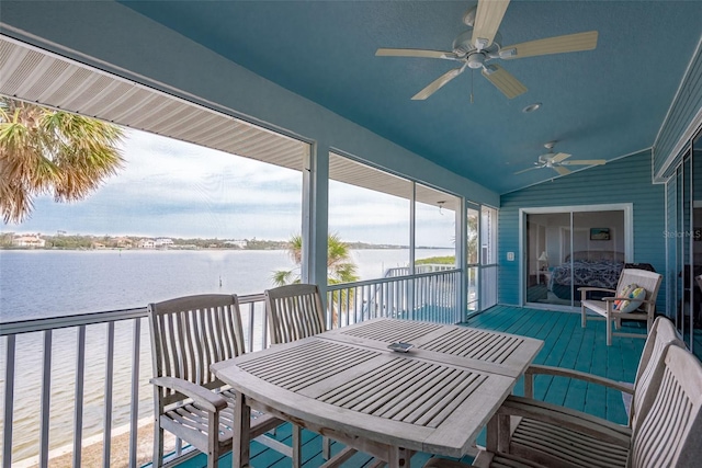 exterior space with ceiling fan and a water view