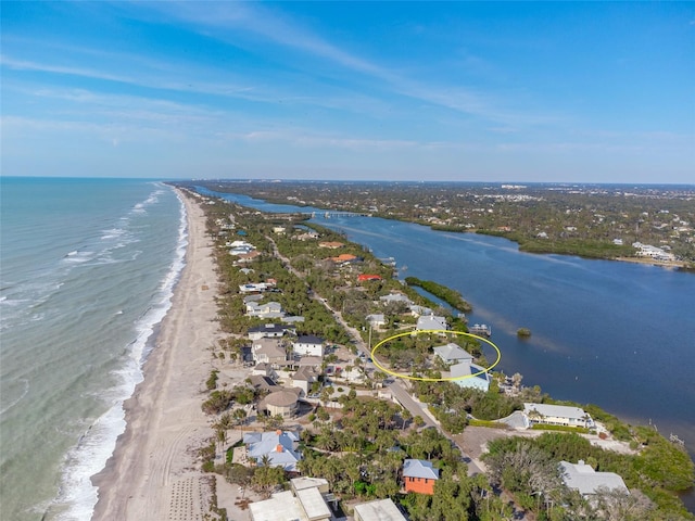 drone / aerial view featuring a water view and a view of the beach