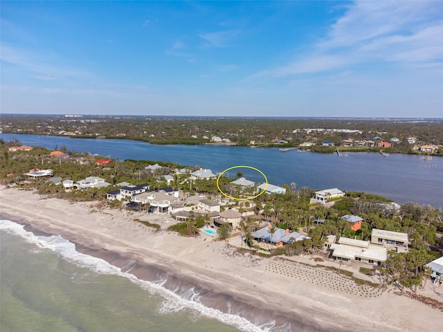 drone / aerial view with a beach view and a water view