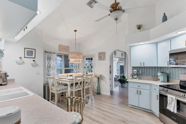 kitchen with stainless steel appliances, decorative light fixtures, sink, and white cabinets