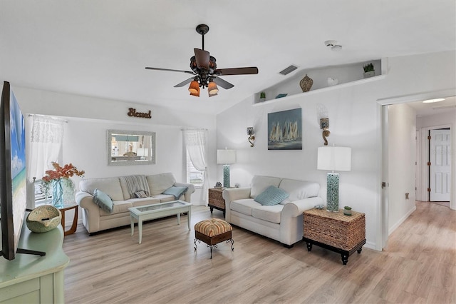 living room featuring lofted ceiling, ceiling fan, and light wood-type flooring