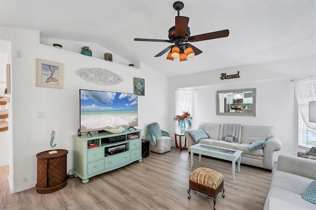 living room featuring lofted ceiling, light hardwood / wood-style flooring, and ceiling fan