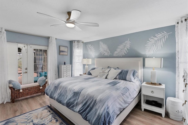 bedroom featuring ceiling fan, access to exterior, multiple windows, and light hardwood / wood-style flooring