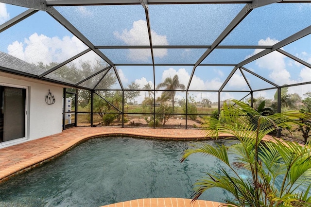 view of swimming pool with a patio and glass enclosure