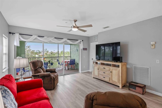 living room with ceiling fan and light wood-type flooring