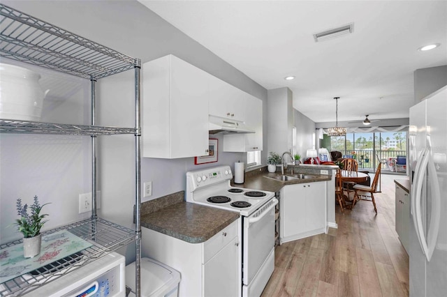 kitchen with white electric stove and white cabinetry