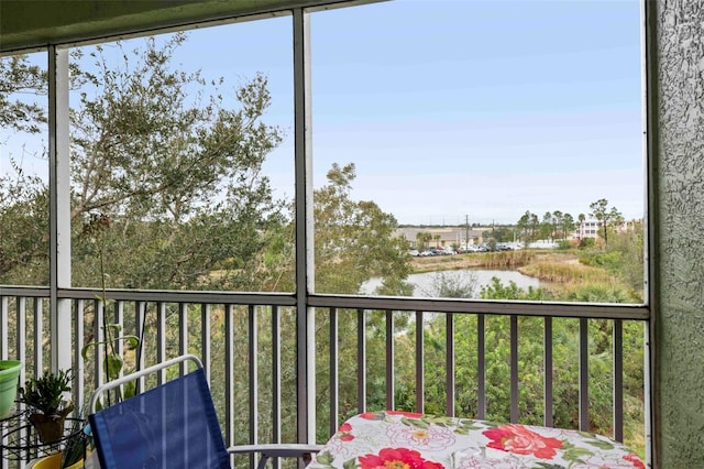 unfurnished sunroom with a water view