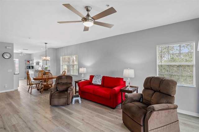 living room with light hardwood / wood-style floors and ceiling fan