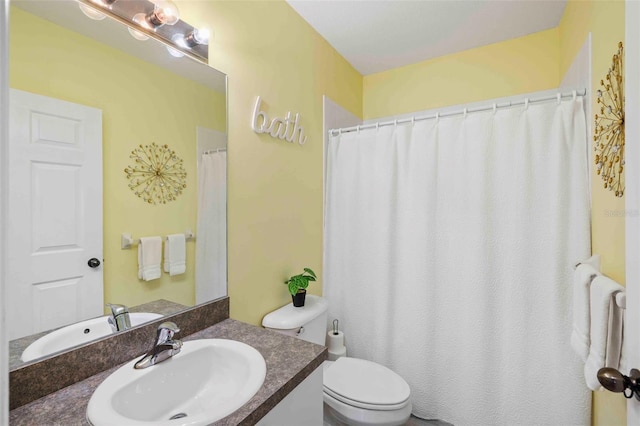 bathroom featuring toilet and vanity