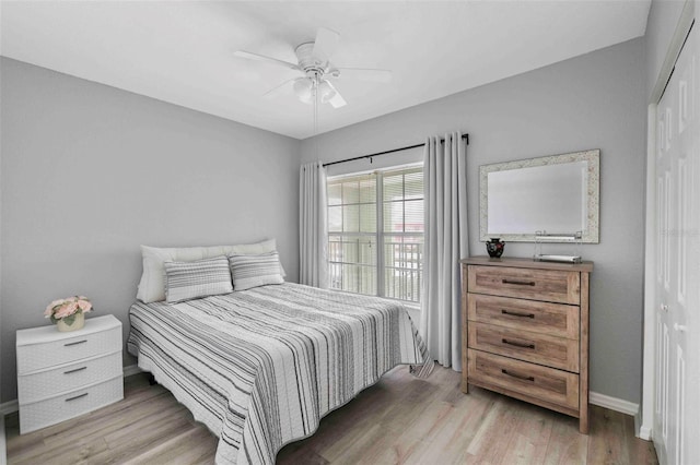 bedroom with light hardwood / wood-style flooring, a closet, and ceiling fan