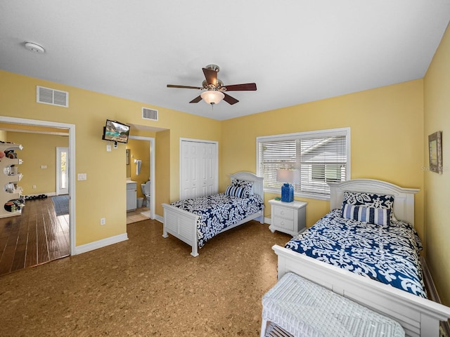 bedroom with ensuite bath, ceiling fan, and a closet