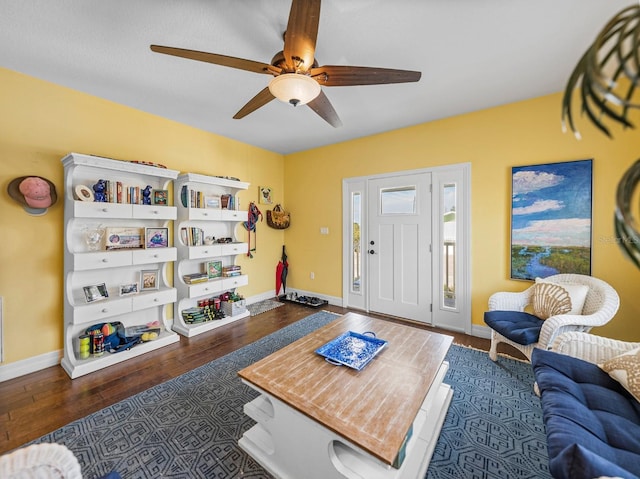 interior space featuring ceiling fan and dark hardwood / wood-style floors