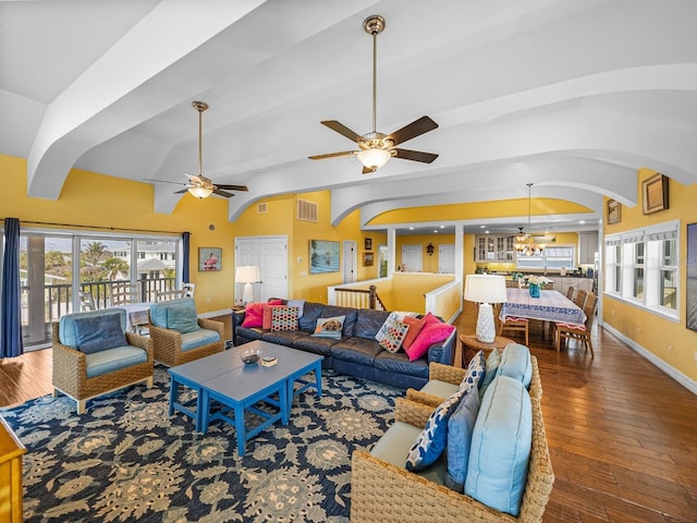 living room with dark hardwood / wood-style flooring, vaulted ceiling with beams, and ceiling fan