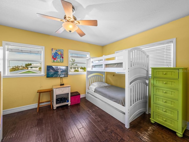 bedroom with ceiling fan and dark hardwood / wood-style flooring