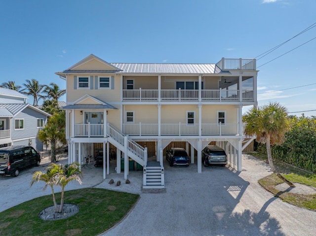 coastal home with a carport, a balcony, and a porch