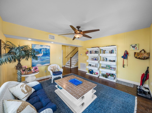 living room with ceiling fan and dark hardwood / wood-style flooring