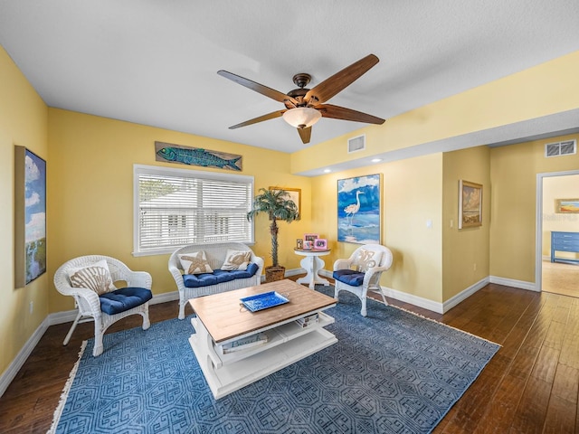 living room with ceiling fan and dark hardwood / wood-style flooring