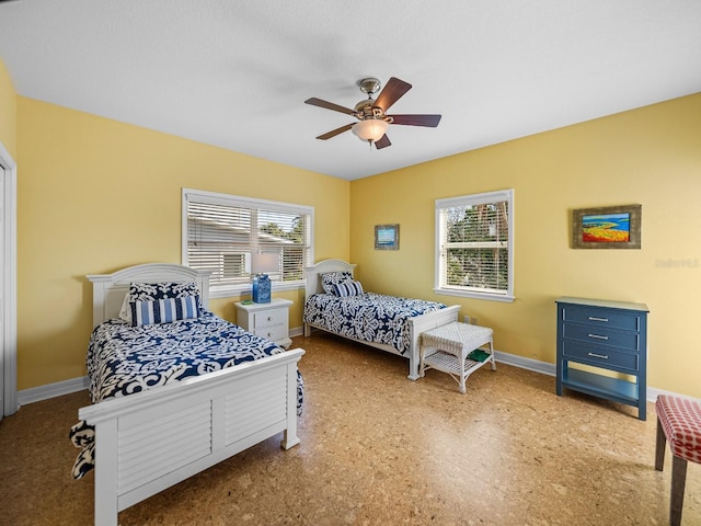 bedroom with multiple windows and ceiling fan