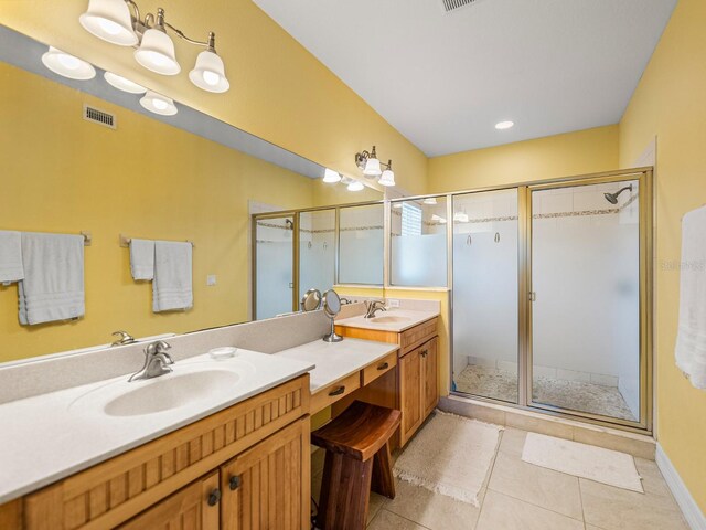 bathroom with vanity, an enclosed shower, and tile patterned flooring